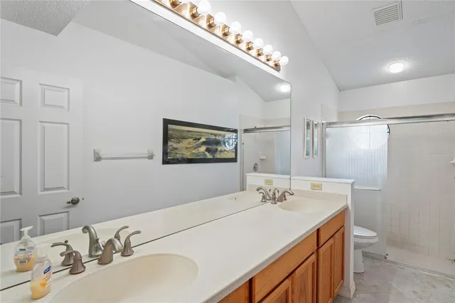 a bathroom with a shower curtain a sink and a toilet
