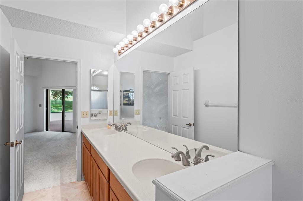 9108 Bassett Lane, Unit B New Port Richey, FL 34655 - Photo 28 of 66 a bathroom with a tub sink and mirror