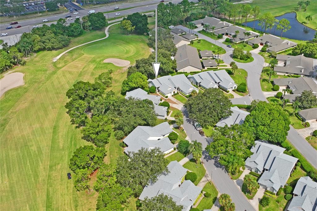 9108 Bassett Lane, Unit B New Port Richey, FL 34655 - Photo 55 of 66 an aerial view of residential house with swimming pool and lawn chairs