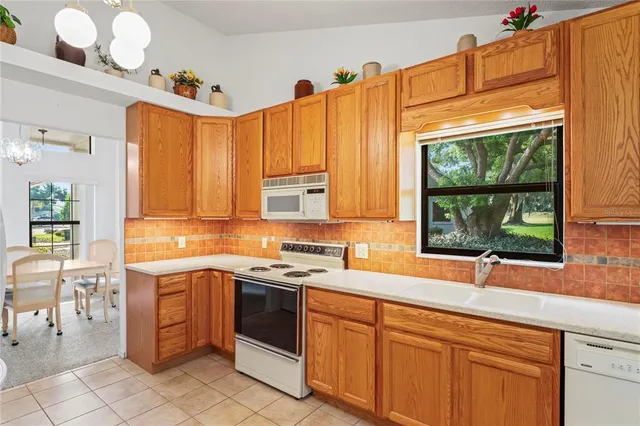 a kitchen with a sink a counter top space and appliances