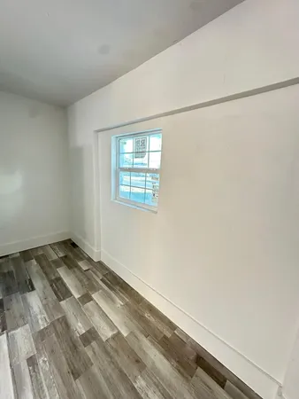 a view of a livingroom with wooden floor and window