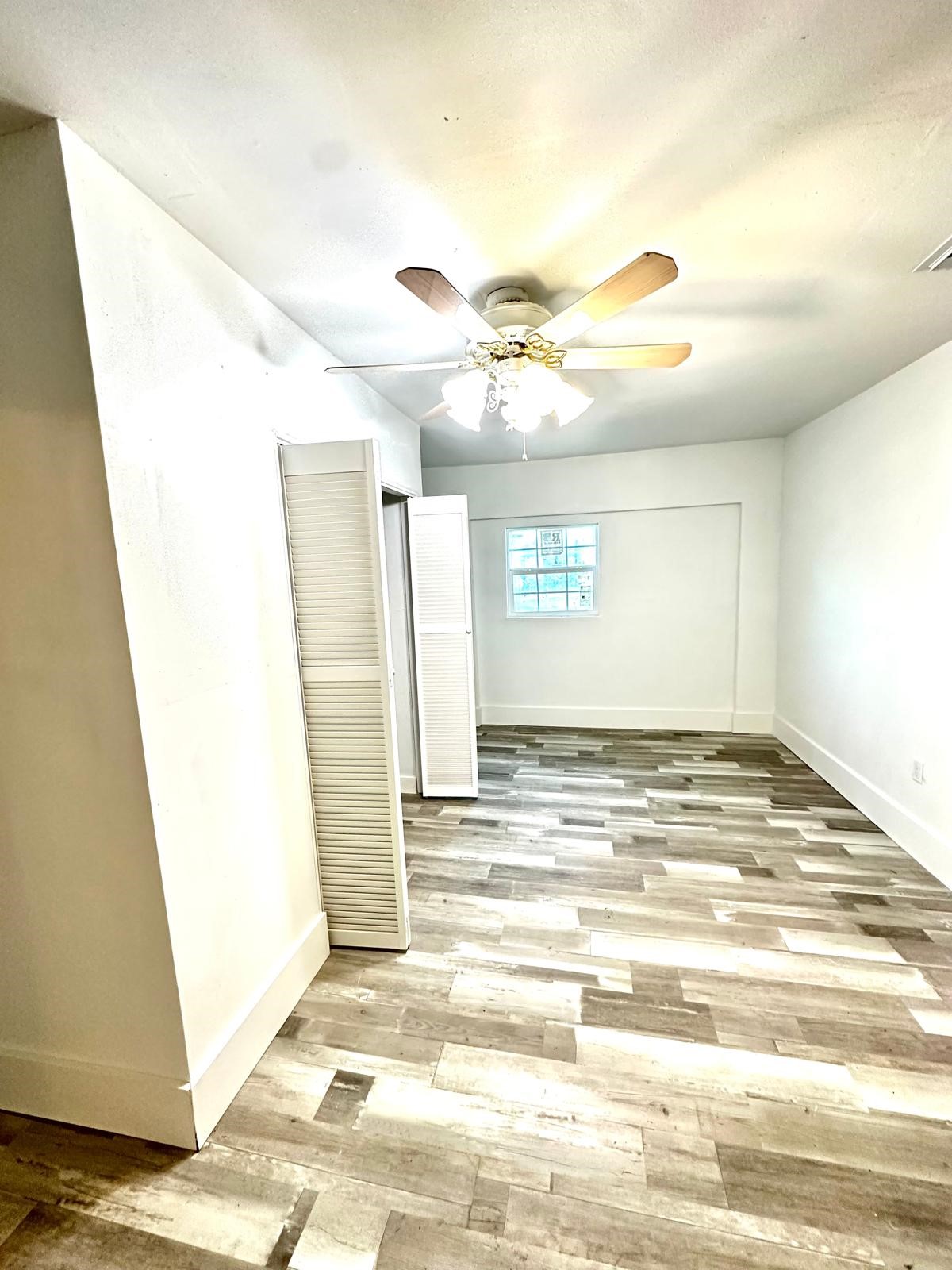 600 West Mimosa Street Angleton, TX 77515 - Photo 15 of 18 a view of a livingroom with wooden floor and window