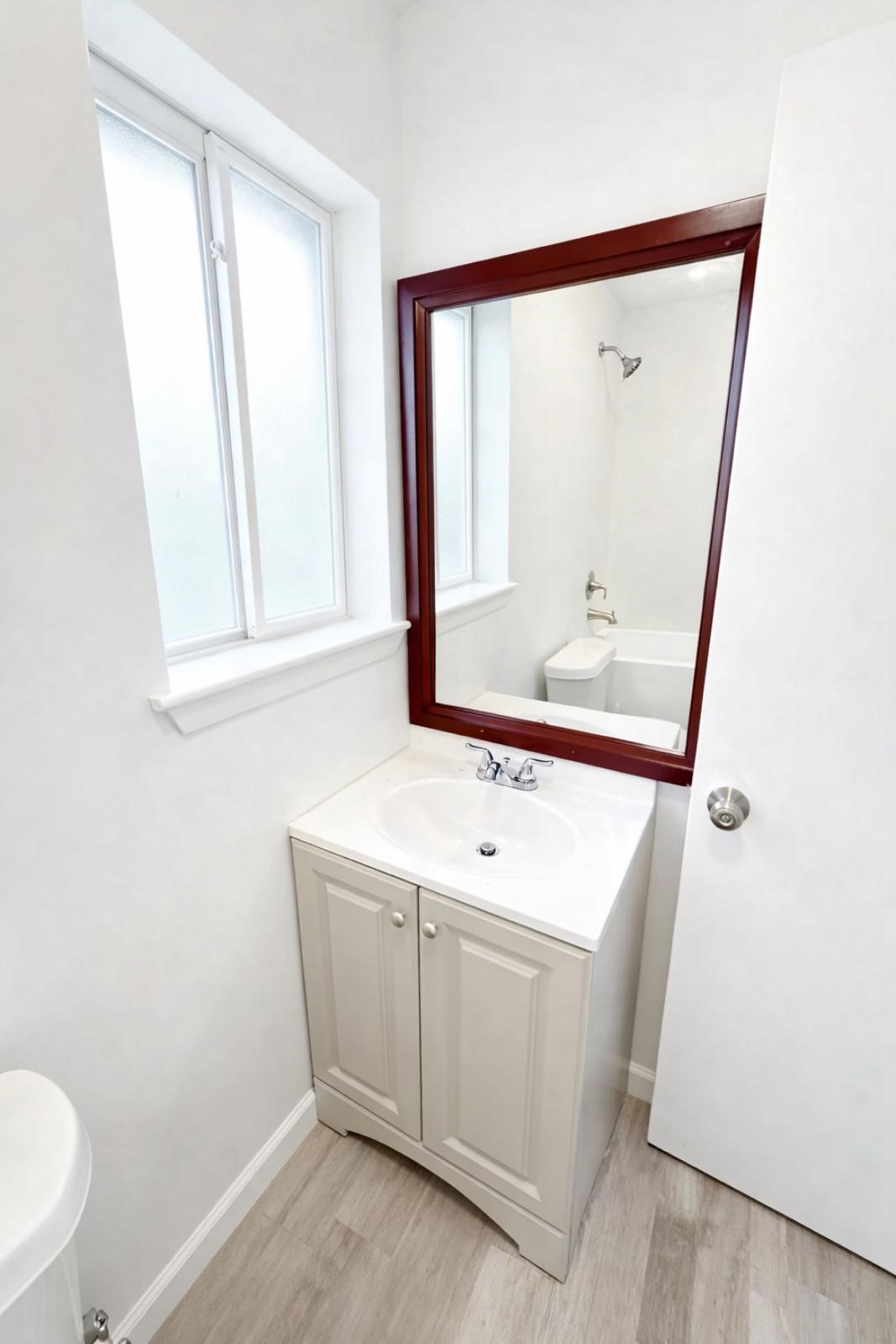 600 West Mimosa Street Angleton, TX 77515 - Photo 17 of 18 a bathroom with a sink a mirror and a toilet