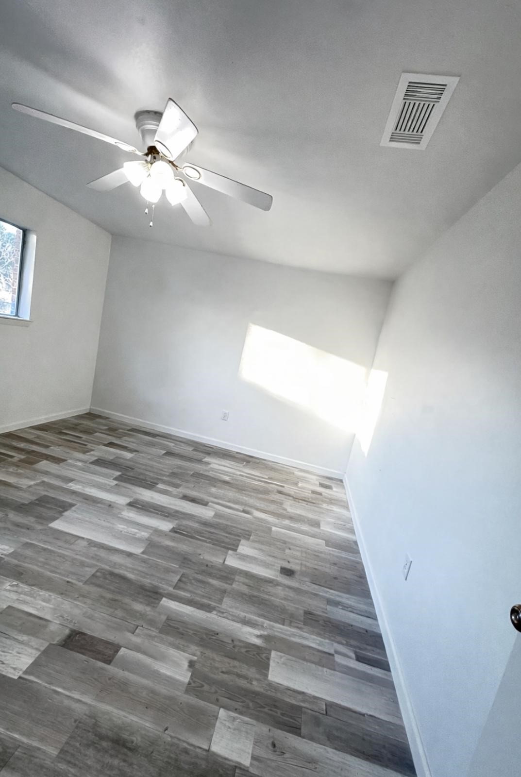 600 West Mimosa Street Angleton, TX 77515 - Photo 18 of 18 a view of a big room with wooden floor and windows