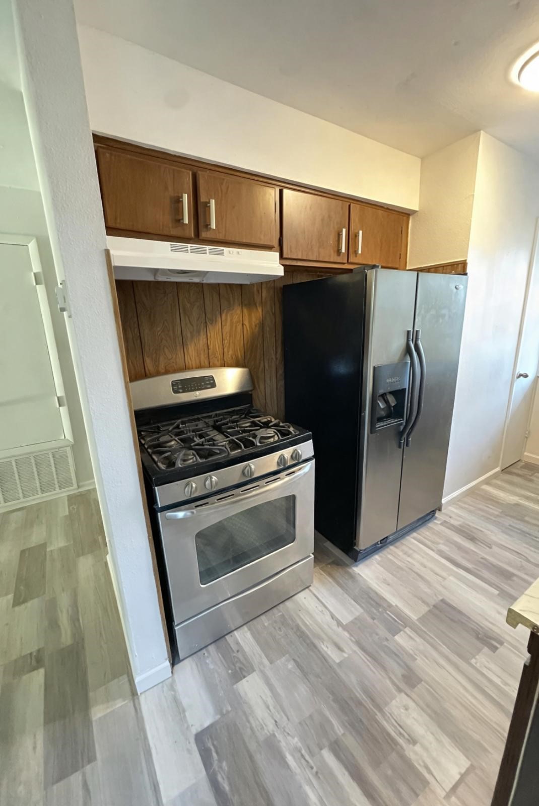 600 West Mimosa Street Angleton, TX 77515 - Photo 4 of 18 a kitchen with a stove and a refrigerator
