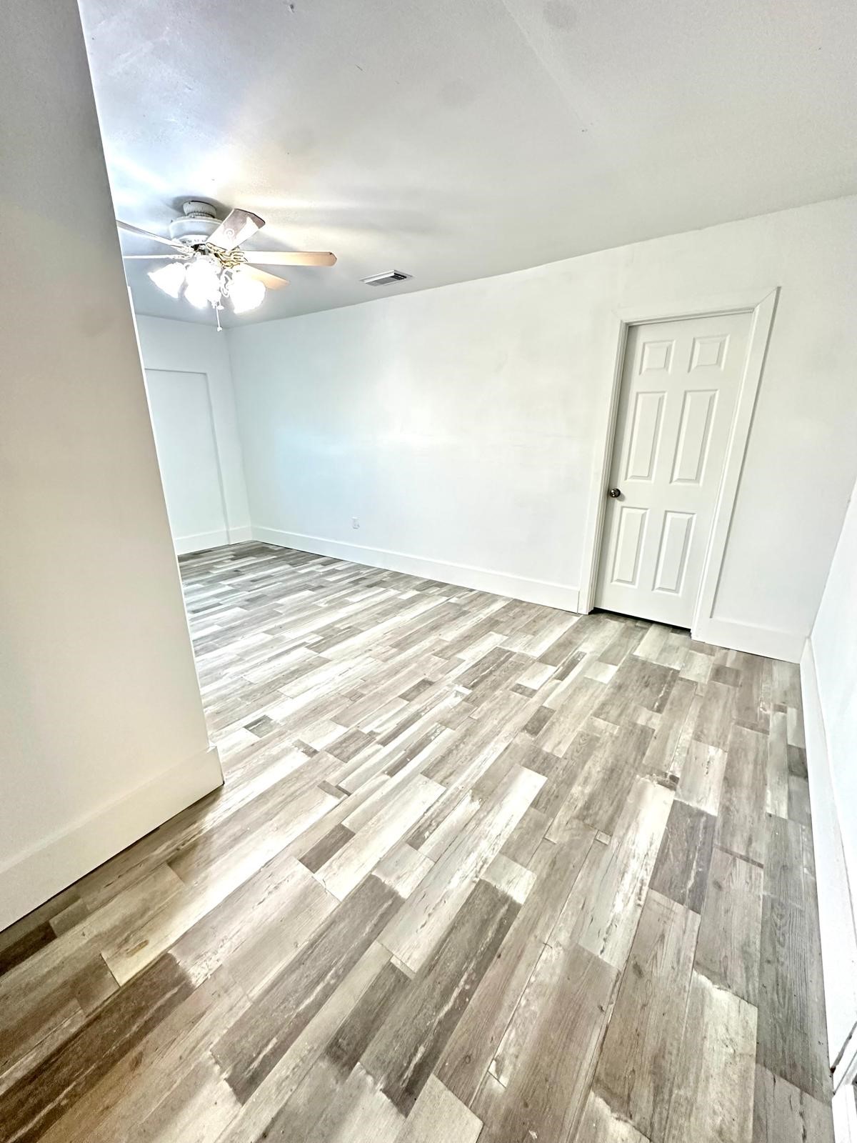 600 West Mimosa Street Angleton, TX 77515 - Photo 7 of 18 a view of a livingroom with wooden floor and chandelier