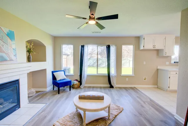 a living room with furniture and a wooden floor