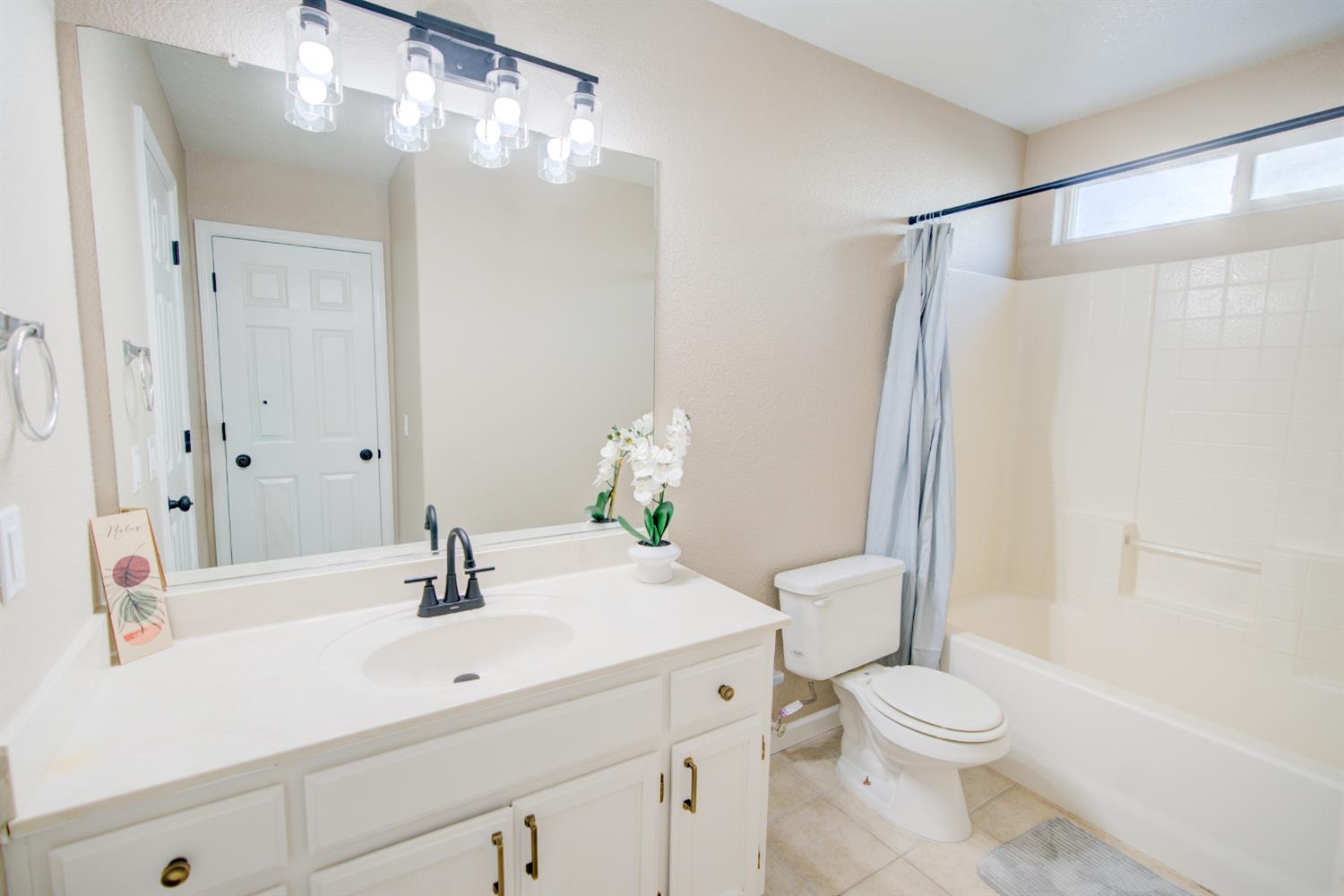 3546 Paseo Verde Avenue Merced, CA 95348 - Photo 12 of 24 a bathroom with a sink a toilet and shower