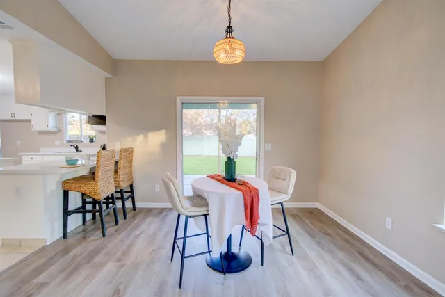 a dining room with furniture and wooden floor