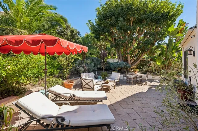 a bedroom with a bed chandelier and a window
