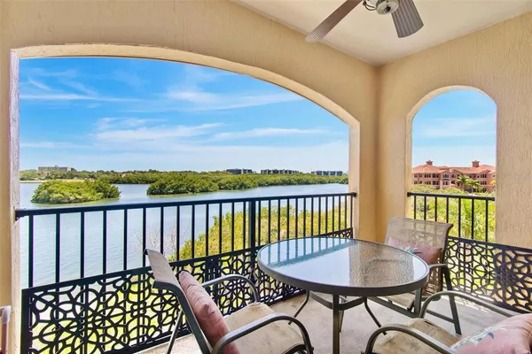 a view of a chairs and table in the balcony