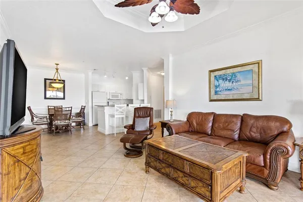 a living room with furniture and a chandelier