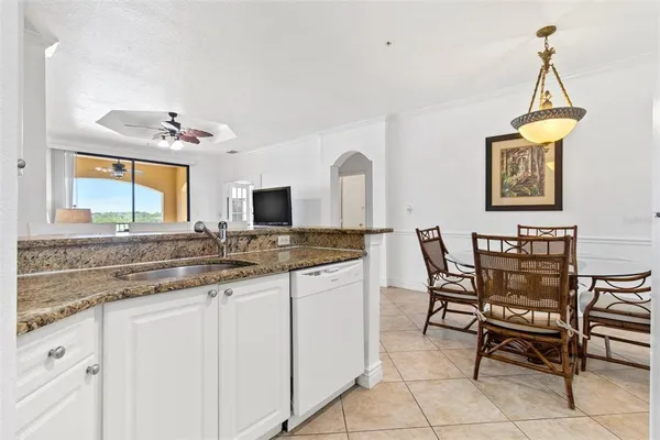 a kitchen with cabinets and chairs