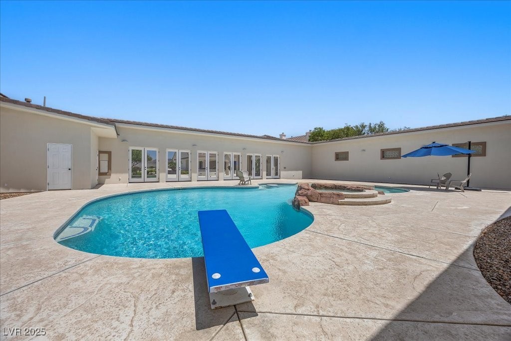 640 Quail Covey Road Henderson, NV 89002 - Photo 53 of 75 View of pool with a patio, a diving board, and a pool with connected hot tub