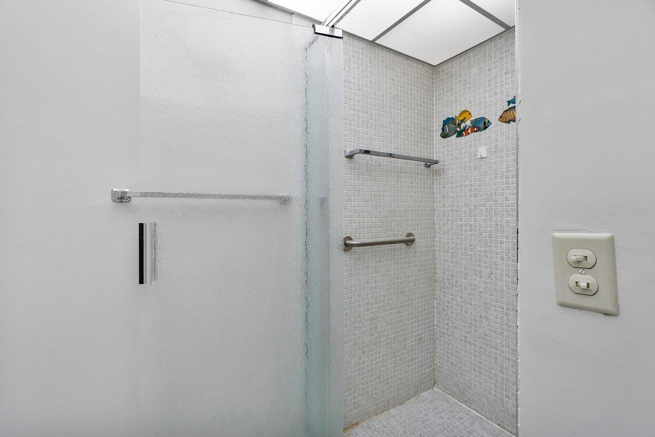 77 Normandy B Delray Beach, FL 33484 - Photo 13 of 34 a bathroom with a shower