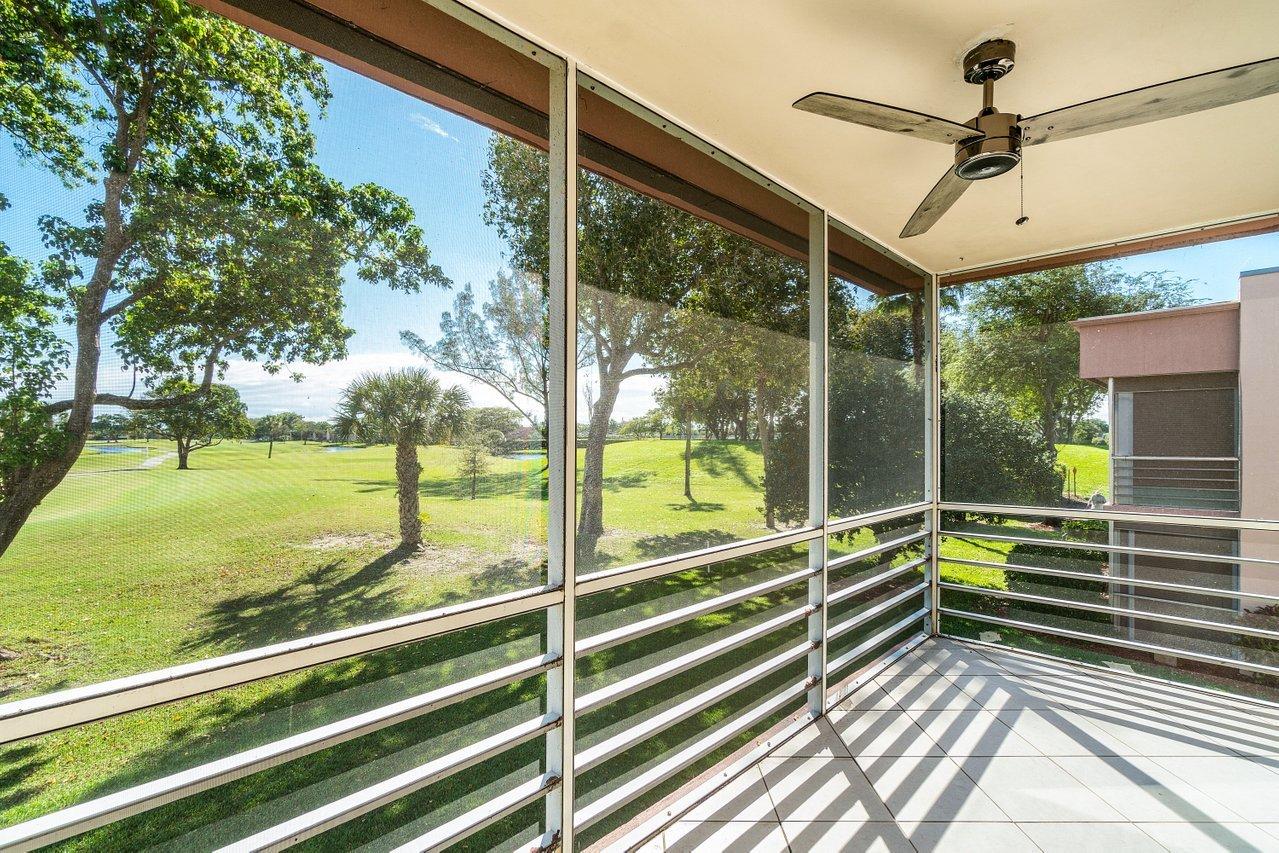 77 Normandy B Delray Beach, FL 33484 - Photo 16 of 34 a view of a porch and garden