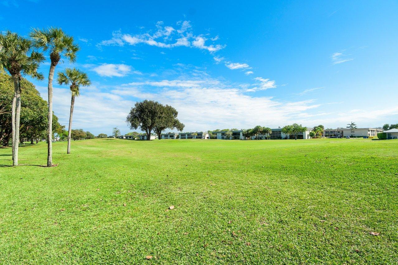 77 Normandy B Delray Beach, FL 33484 - Photo 18 of 34 a view of a golf course with a garden