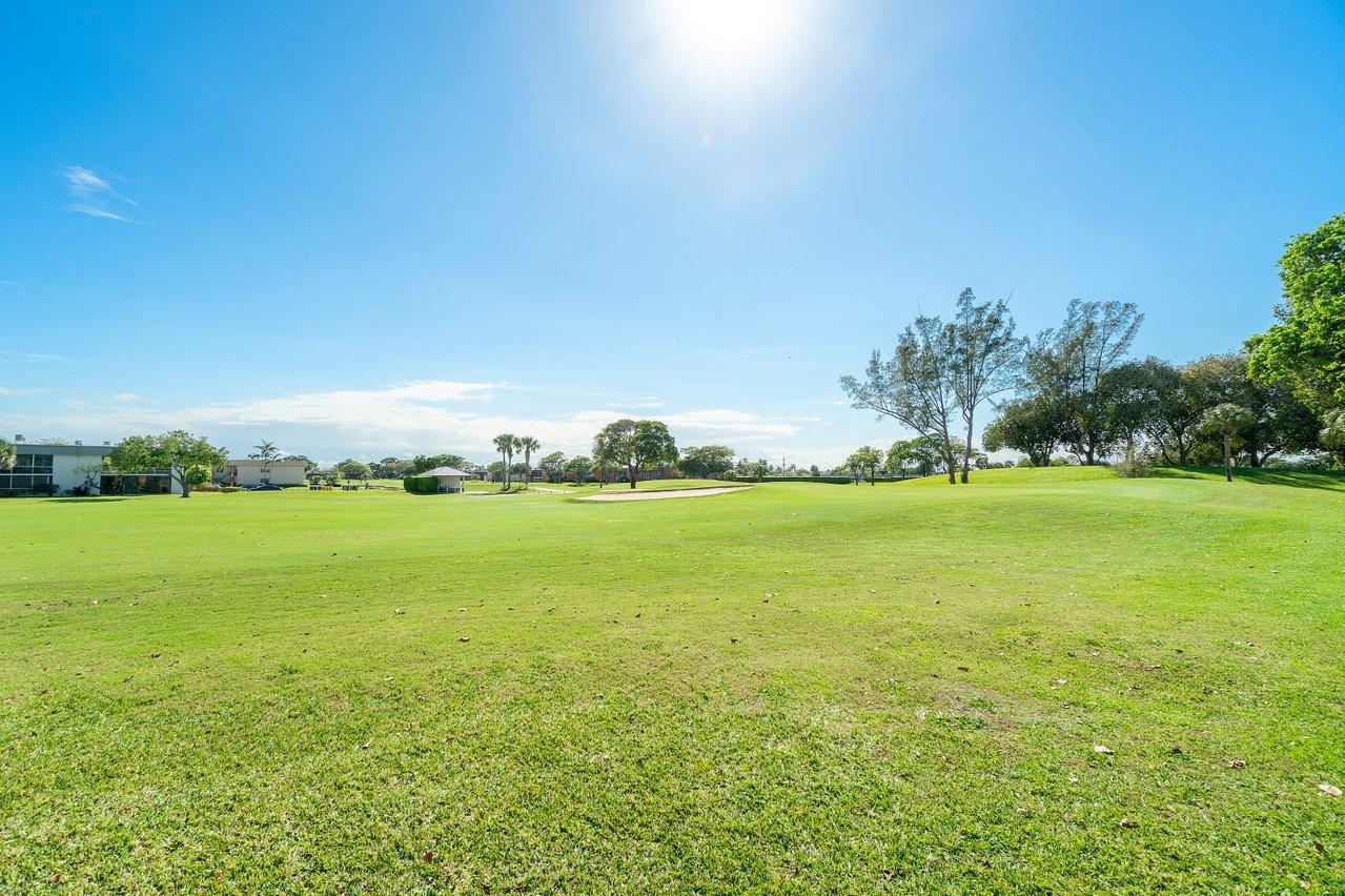 77 Normandy B Delray Beach, FL 33484 - Photo 19 of 34 a view of an ocean from a yard