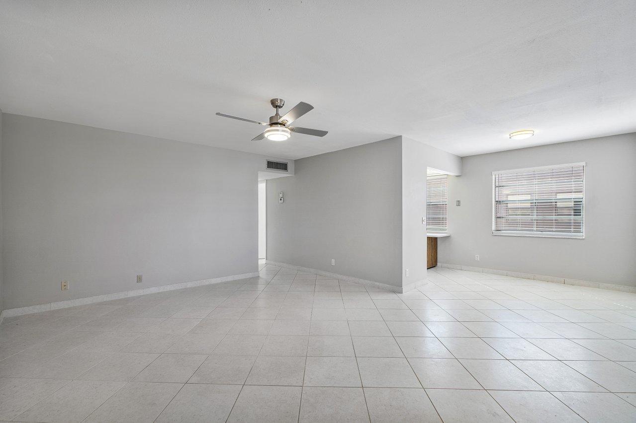 77 Normandy B Delray Beach, FL 33484 - Photo 5 of 34 a view of an empty room with a window