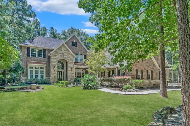 a view of a chairs and table in the backyard