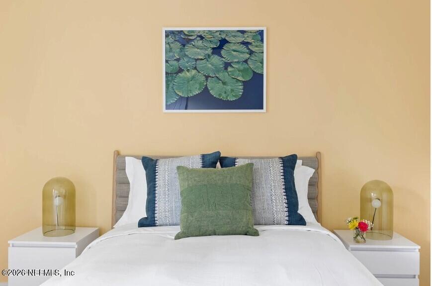 402 3rd Street St. Augustine, FL 32084 - Photo 12 of 29 a bedroom with a bed and a painting on the wall