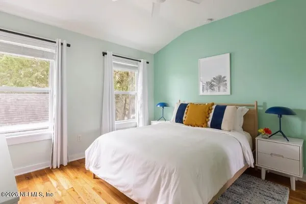 a bed sitting in a bedroom next to a window