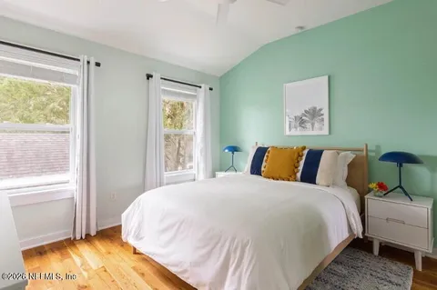 a bed sitting in a bedroom next to a window