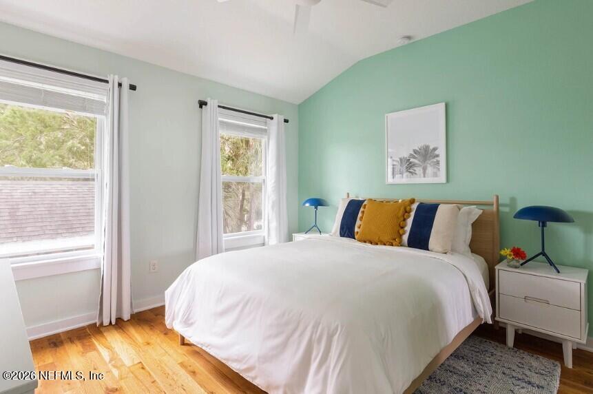 402 3rd Street St. Augustine, FL 32084 - Photo 8 of 29 a bed sitting in a bedroom next to a window
