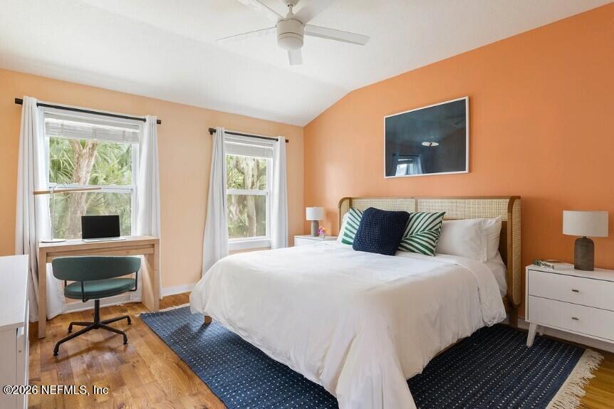 402 3rd Street St. Augustine, FL 32084 - Photo 10 of 29 a bedroom with a bed a table and windows