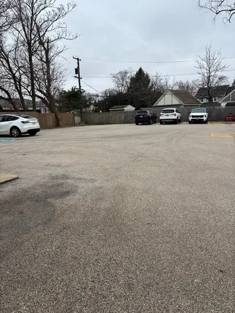 a view of kitchen with kitchen island stainless steel appliances a sink cabinets and a wooden floor