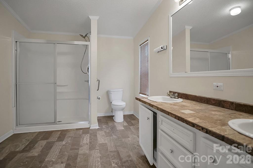 620 Anthony Grove Road Cherryville, NC 28021 - Photo 20 of 32 a bathroom with a granite countertop sink toilet and shower