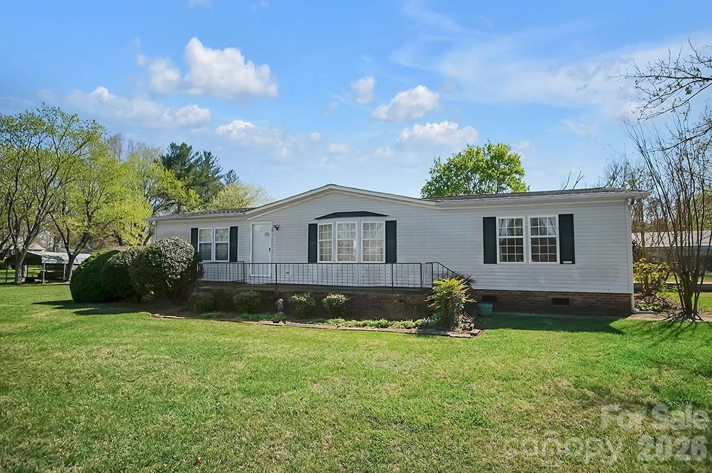620 Anthony Grove Road Cherryville, NC 28021 - Photo 2 of 32 a front view of a house with a garden and yard