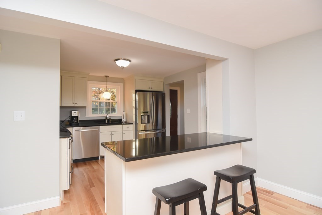 16 Walnut Road Chelmsford, MA 01824 - Photo 10 of 27 a kitchen with a refrigerator and a sink