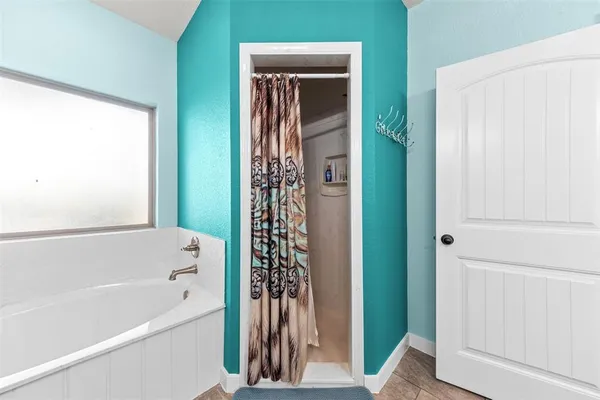 a bathroom with a bathtub and a shower