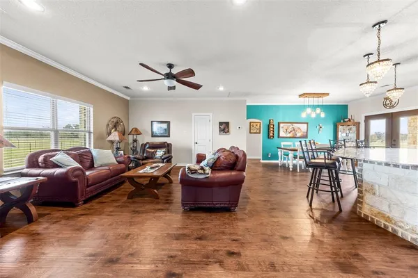 a living room with furniture ceiling fan and a window