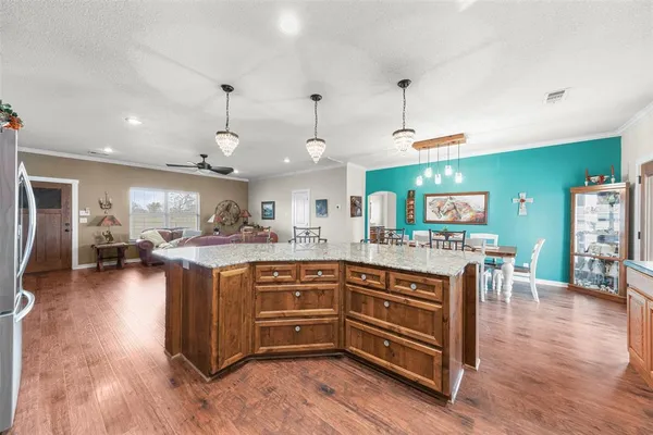 a kitchen with stainless steel appliances granite countertop a stove a sink and a microwave