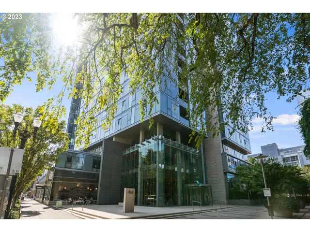 a view of a house with a tree in front