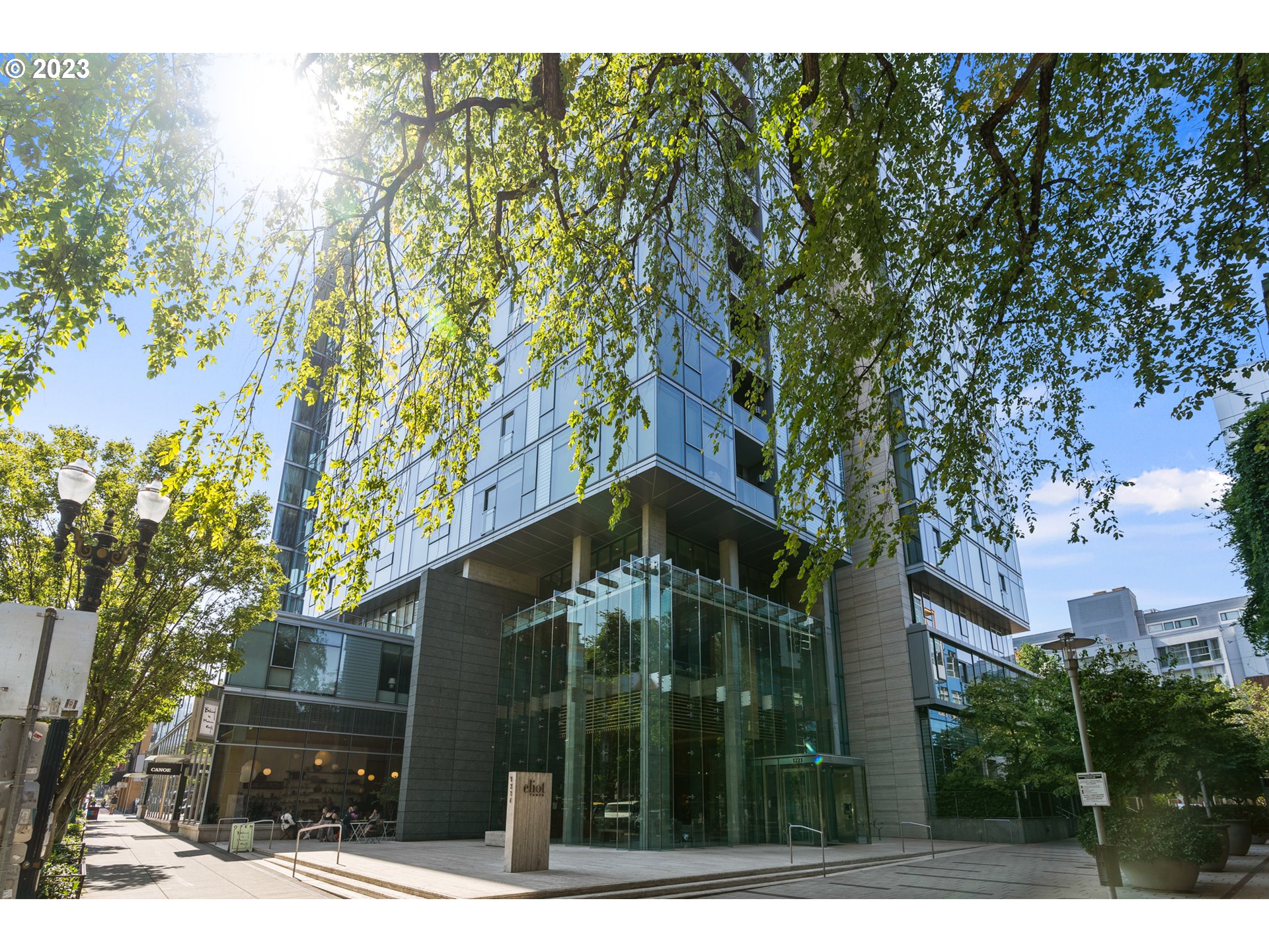 a view of a house with a tree in front