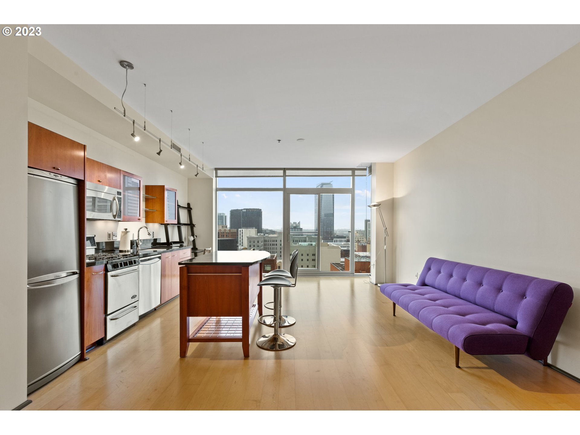 1221 Southwest 10th Avenue, Unit 914 Portland, OR 97205 - Photo 11 of 25 a living room with furniture a large window with kitchen view