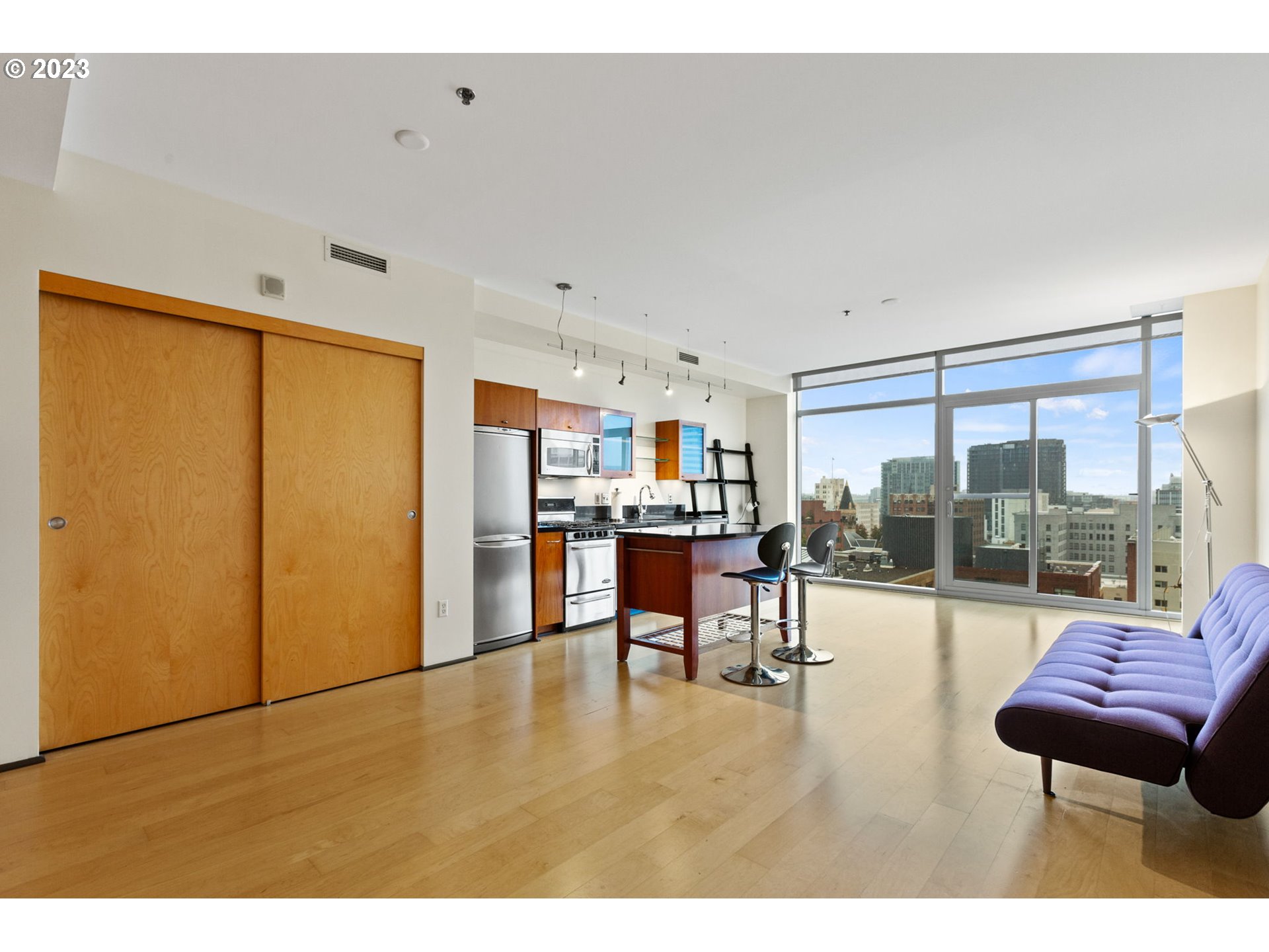 1221 Southwest 10th Avenue, Unit 914 Portland, OR 97205 - Photo 13 of 25 a living room with furniture and a floor to ceiling window