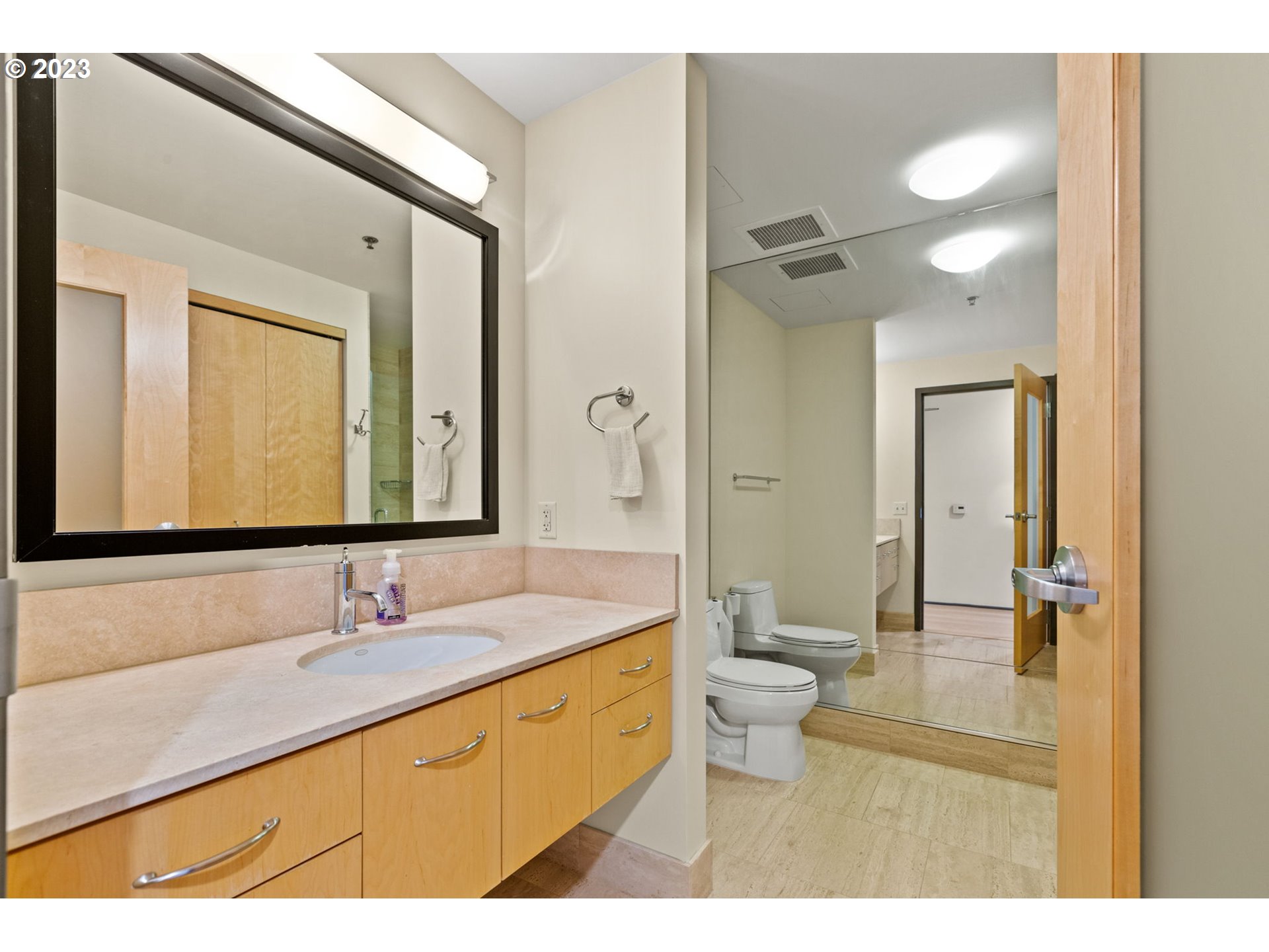 1221 Southwest 10th Avenue, Unit 914 Portland, OR 97205 - Photo 7 of 25 a bathroom with a double vanity sink toilet mirror and shower