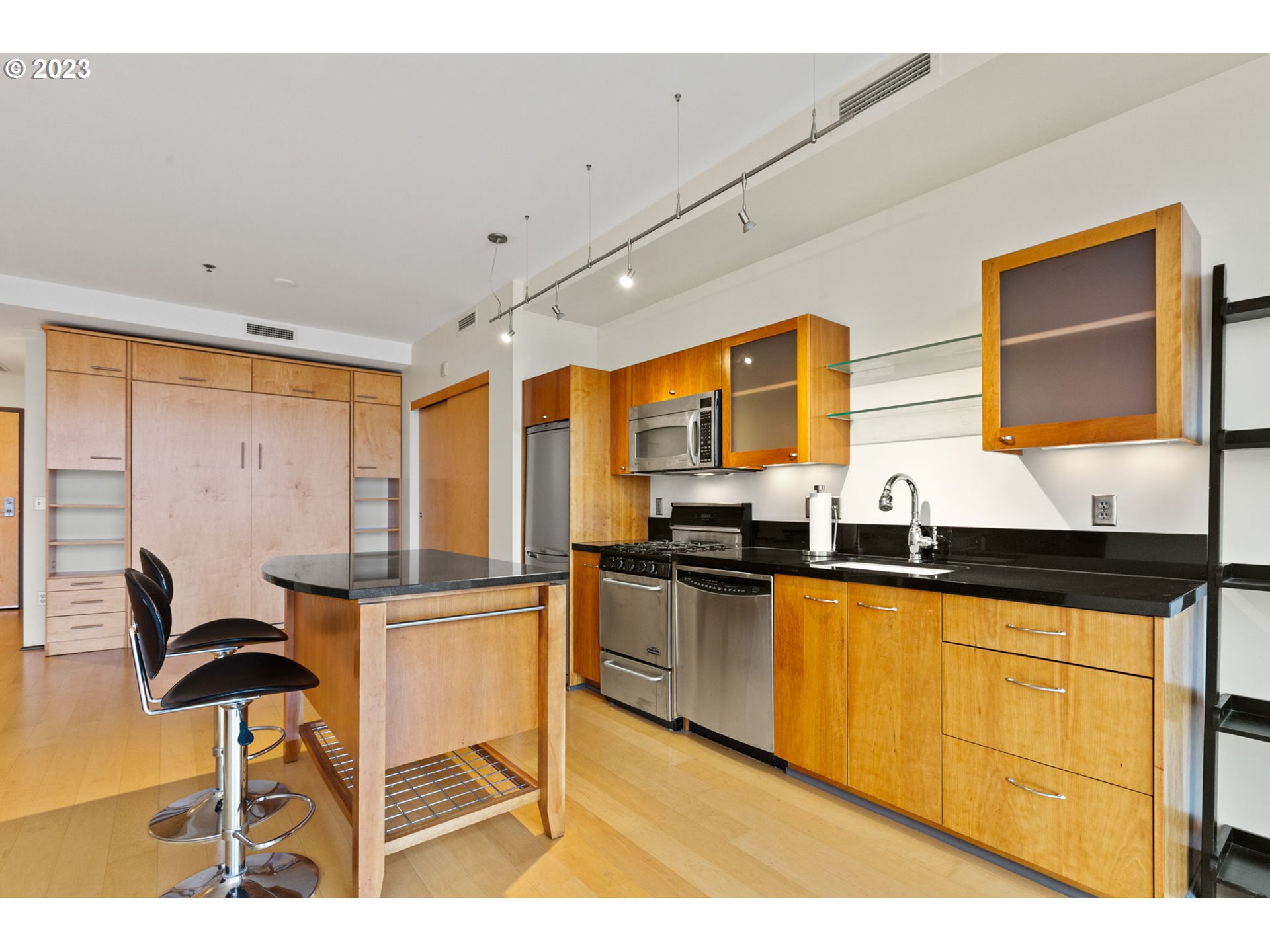 1221 Southwest 10th Avenue, Unit 914 Portland, OR 97205 - Photo 8 of 25 a kitchen with stainless steel appliances granite countertop a sink and cabinets