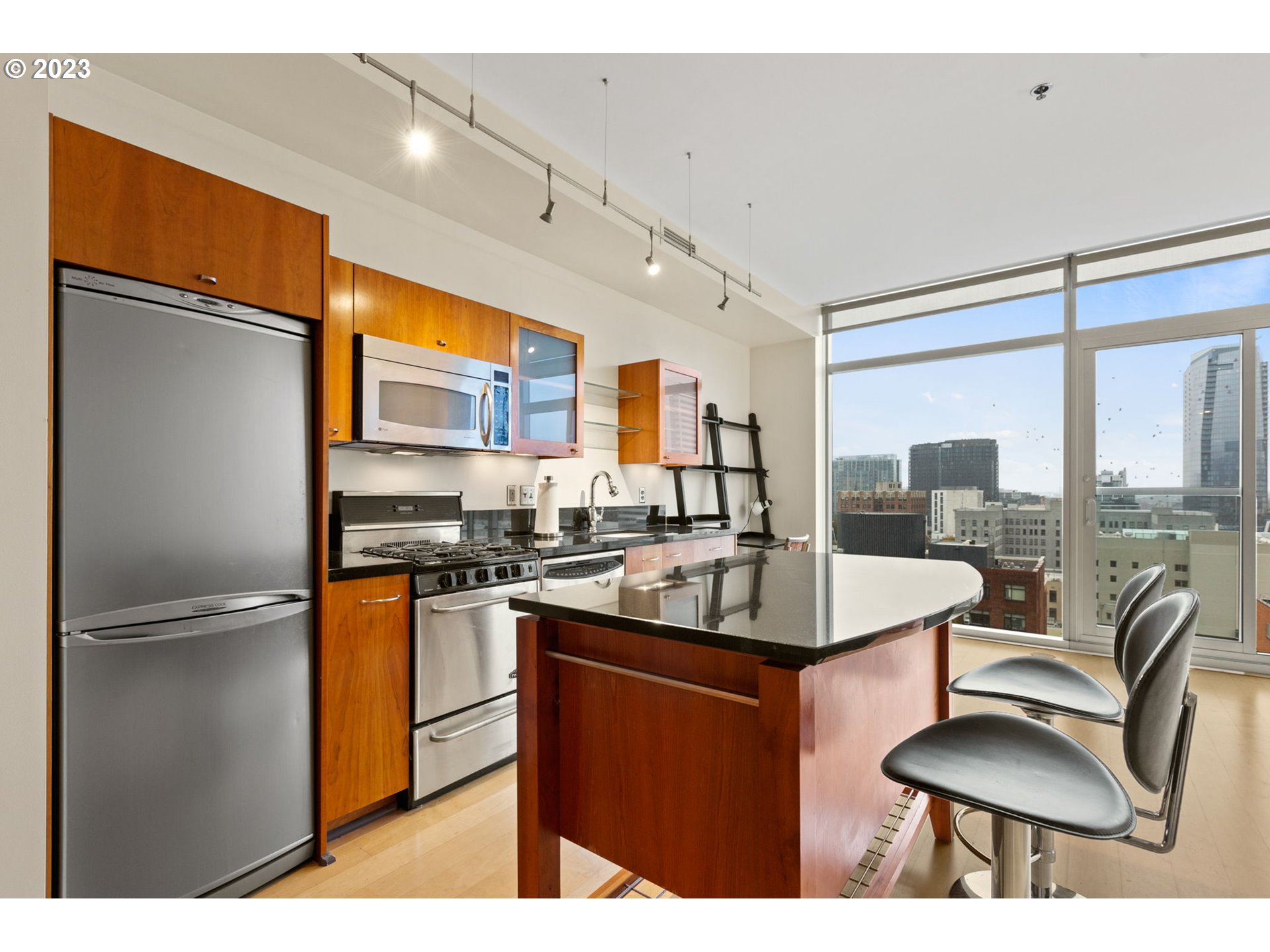 1221 Southwest 10th Avenue, Unit 914 Portland, OR 97205 - Photo 10 of 25 a kitchen with stainless steel appliances granite countertop a sink stove and refrigerator