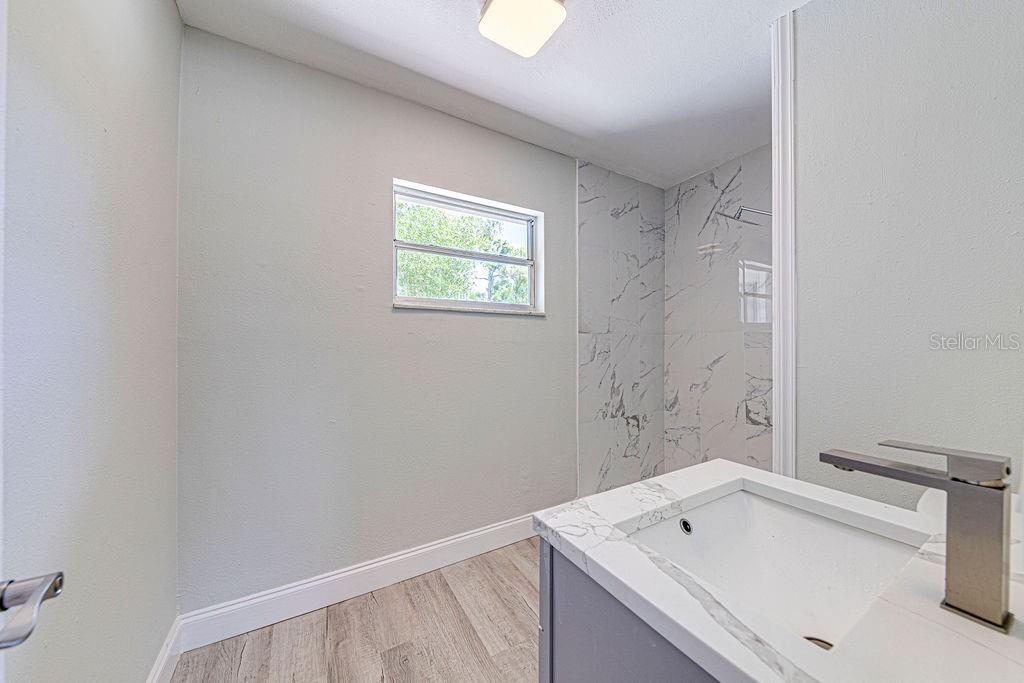 1133 Hermit Smith Road Apopka, FL 32712 - Photo 13 of 34 a bathroom with a sink and a bathtub