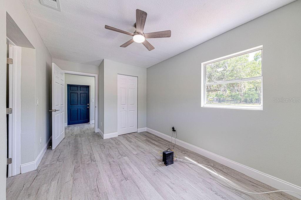 1133 Hermit Smith Road Apopka, FL 32712 - Photo 15 of 34 wooden floor in an empty room with a window