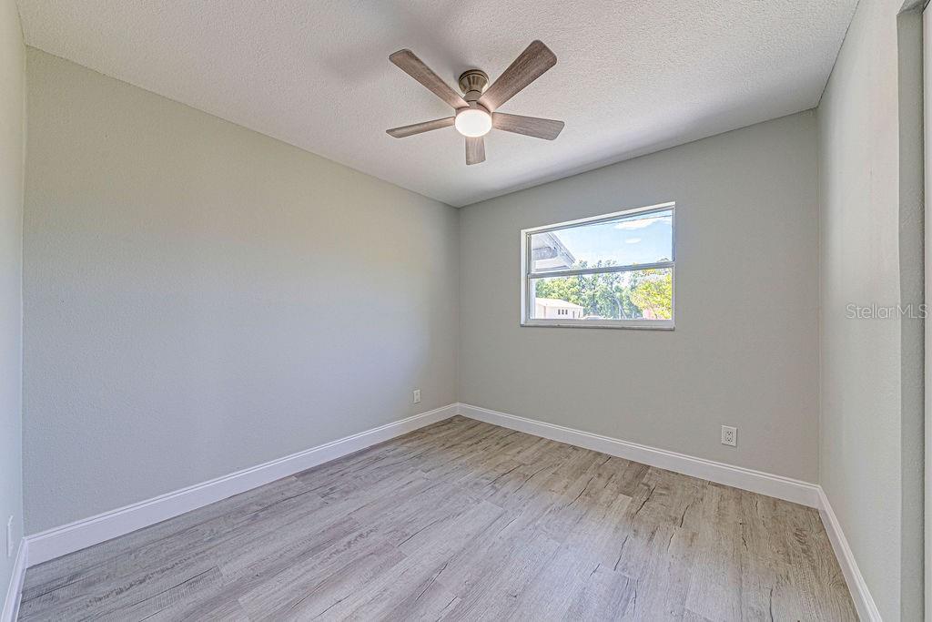 1133 Hermit Smith Road Apopka, FL 32712 - Photo 16 of 34 an empty room with wooden floor and ceiling fan