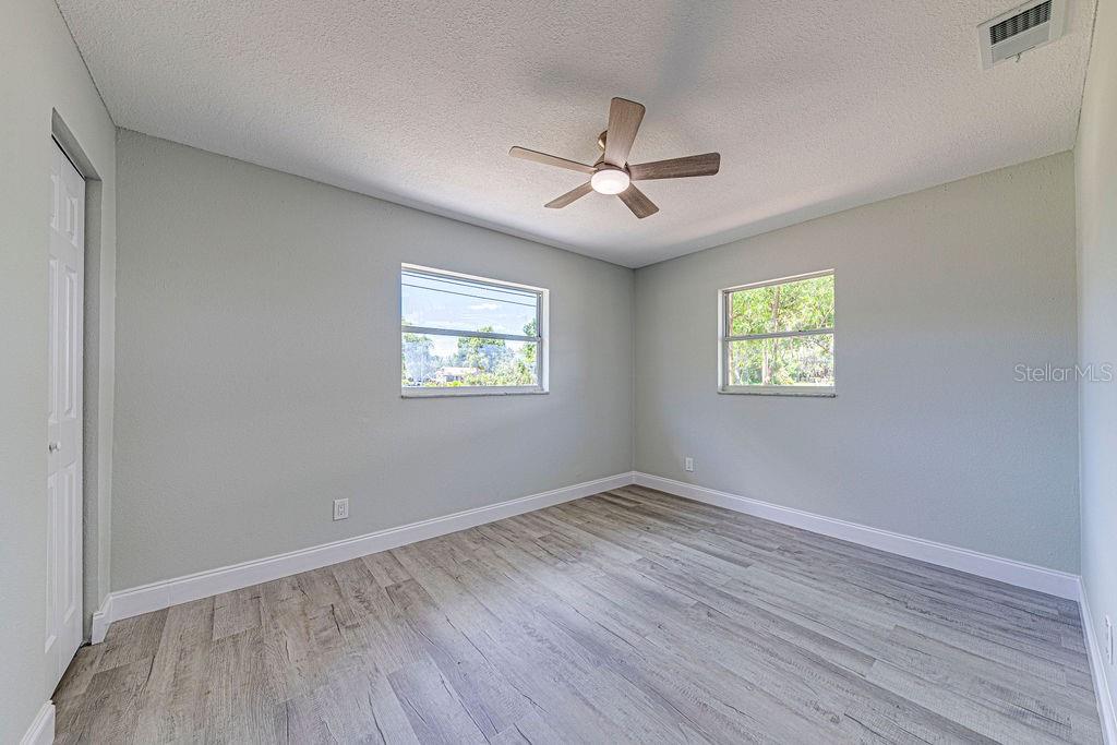 1133 Hermit Smith Road Apopka, FL 32712 - Photo 19 of 34 a view of empty room with wooden floor and fan