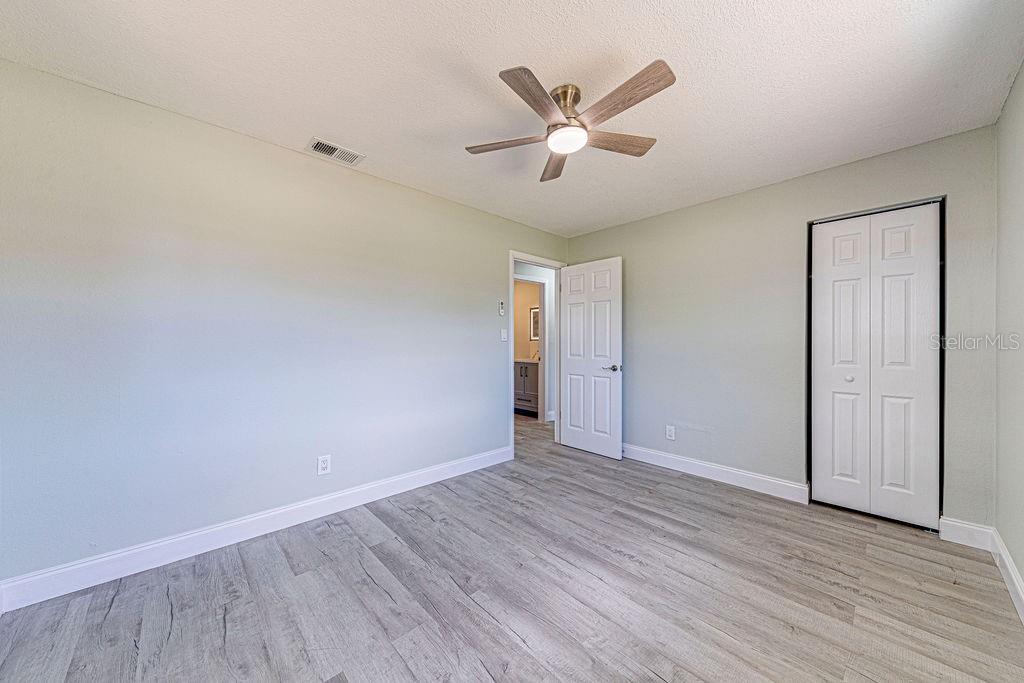 1133 Hermit Smith Road Apopka, FL 32712 - Photo 20 of 34 an empty room with wooden floor and windows