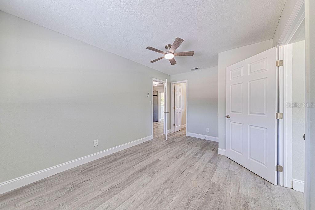1133 Hermit Smith Road Apopka, FL 32712 - Photo 21 of 34 a view of empty room with wooden floor and ceiling fan