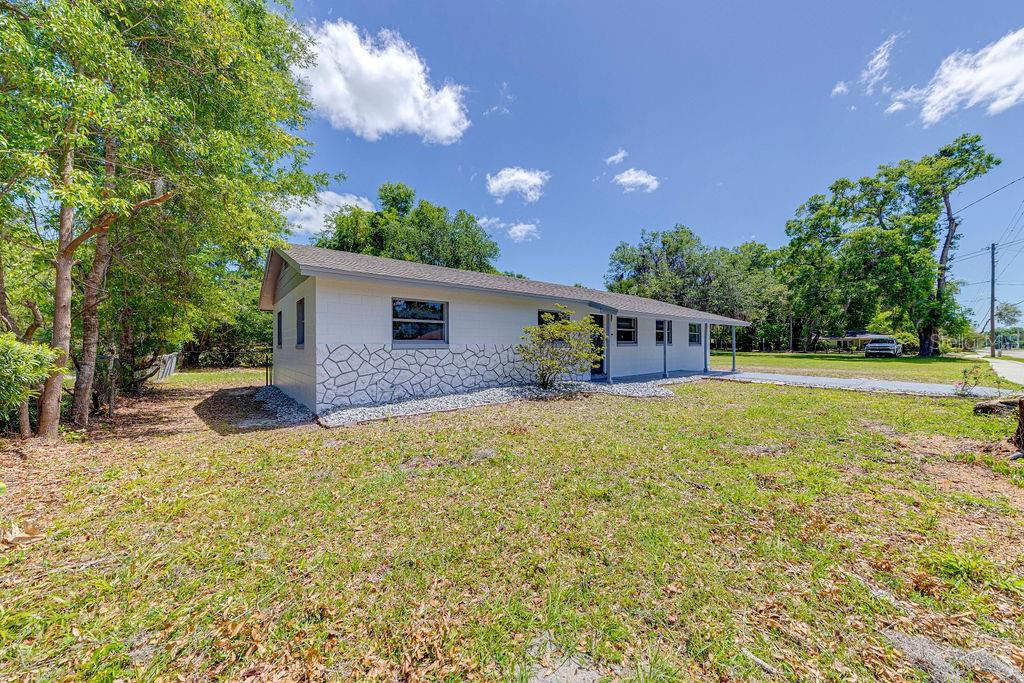 1133 Hermit Smith Road Apopka, FL 32712 - Photo 23 of 34 a front view of house with yard and green space